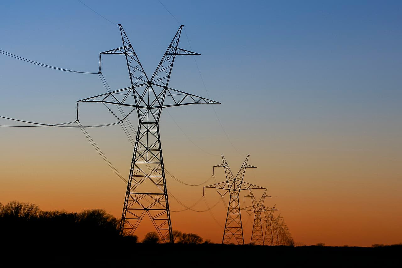 High-voltage transmission towers at sunset in East Texas